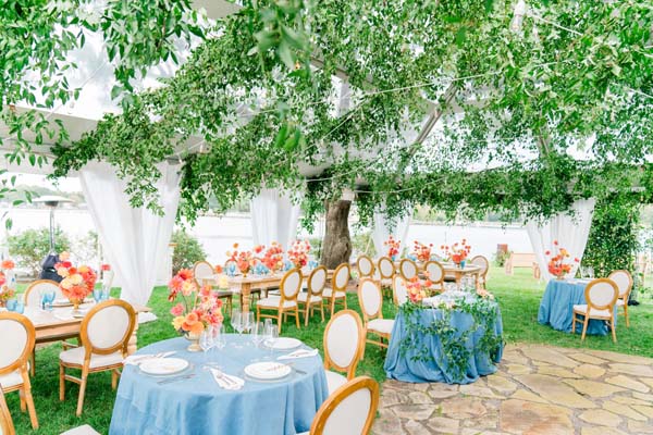 small home wedding - Maryland waterfront wedding secret garden tent blue orange greenery ceiling